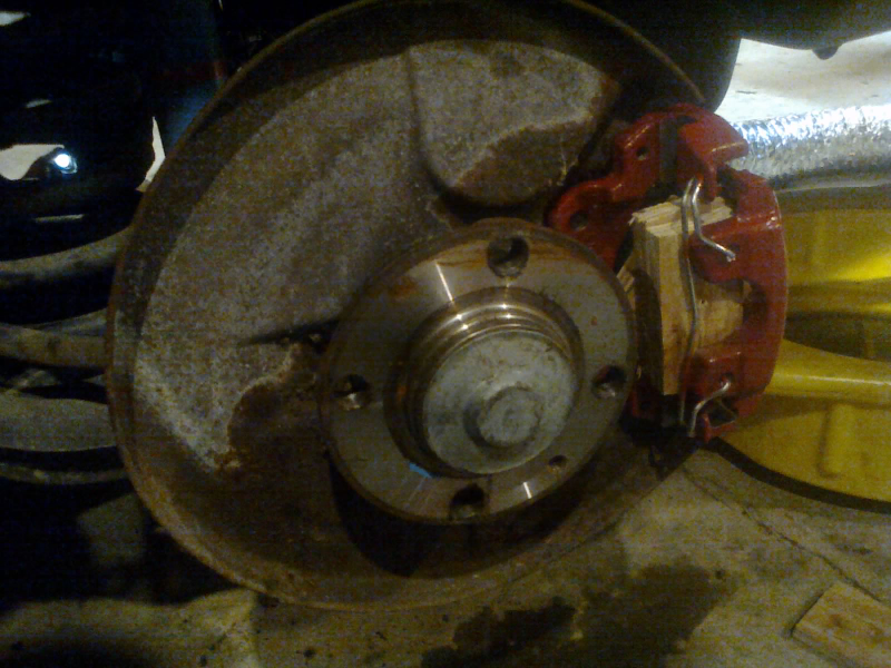 Plywood to simulate pads and rotor to keep the piston from popping out during bleeding